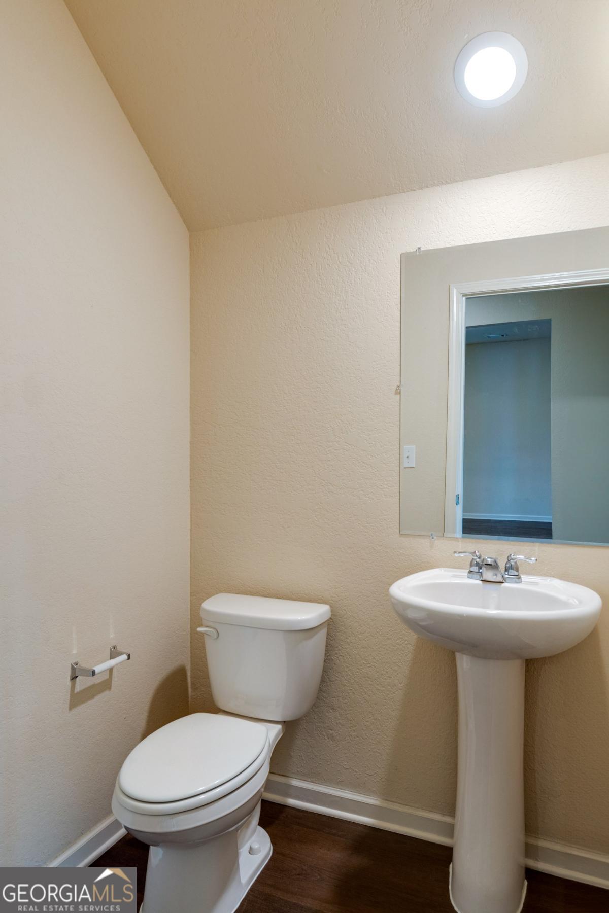 410 Winter Chase Pendergrass, GA 30567 - Photo 10 of 24 a white toilet sitting next to a bathroom sink