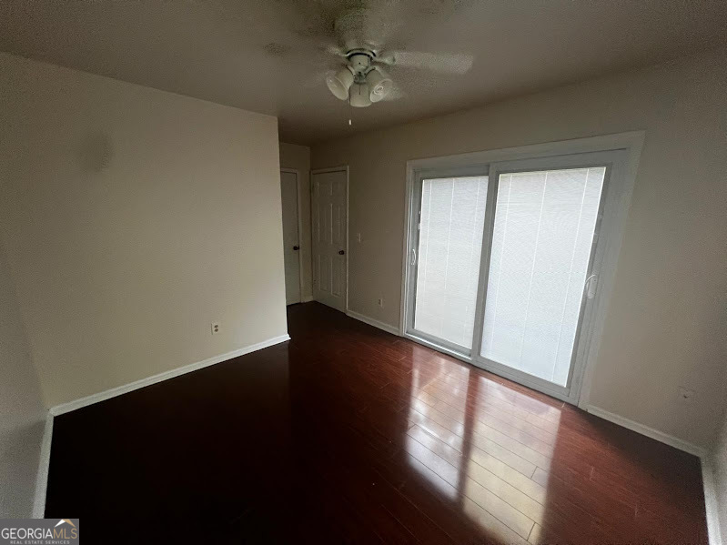 885 Patterns Drive Mableton, GA 30126 - Photo 10 of 22 an empty room with wooden floor and windows
