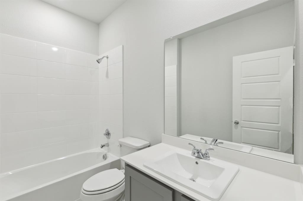 7636 Kingfisher Road Aubrey, TX 76227 - Photo 21 of 34 a bathroom with a sink a toilet and shower