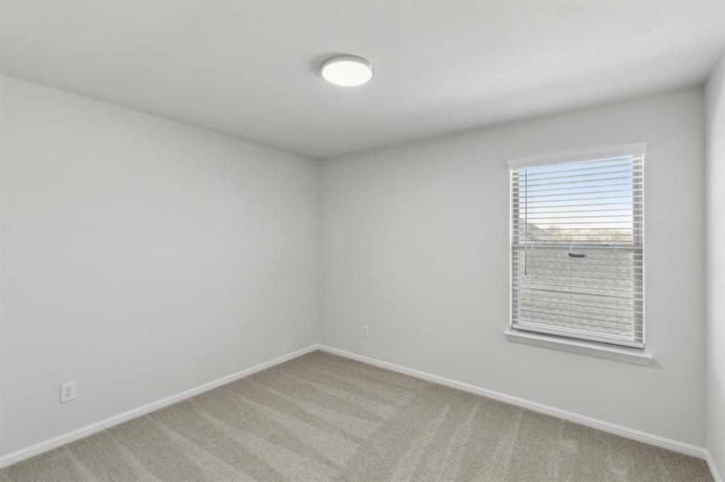 7636 Kingfisher Road Aubrey, TX 76227 - Photo 29 of 34 an empty room with a window