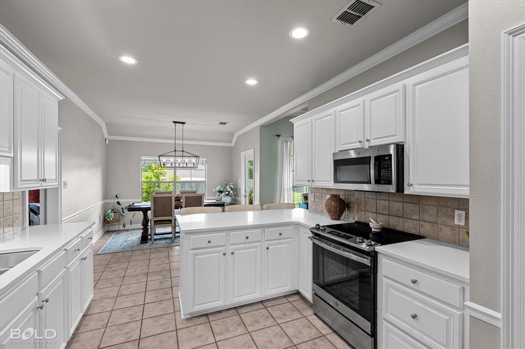 116 Augusta Avenue Benton, LA 71006 - Photo 19 of 38 a kitchen with stainless steel appliances granite countertop a sink and cabinets