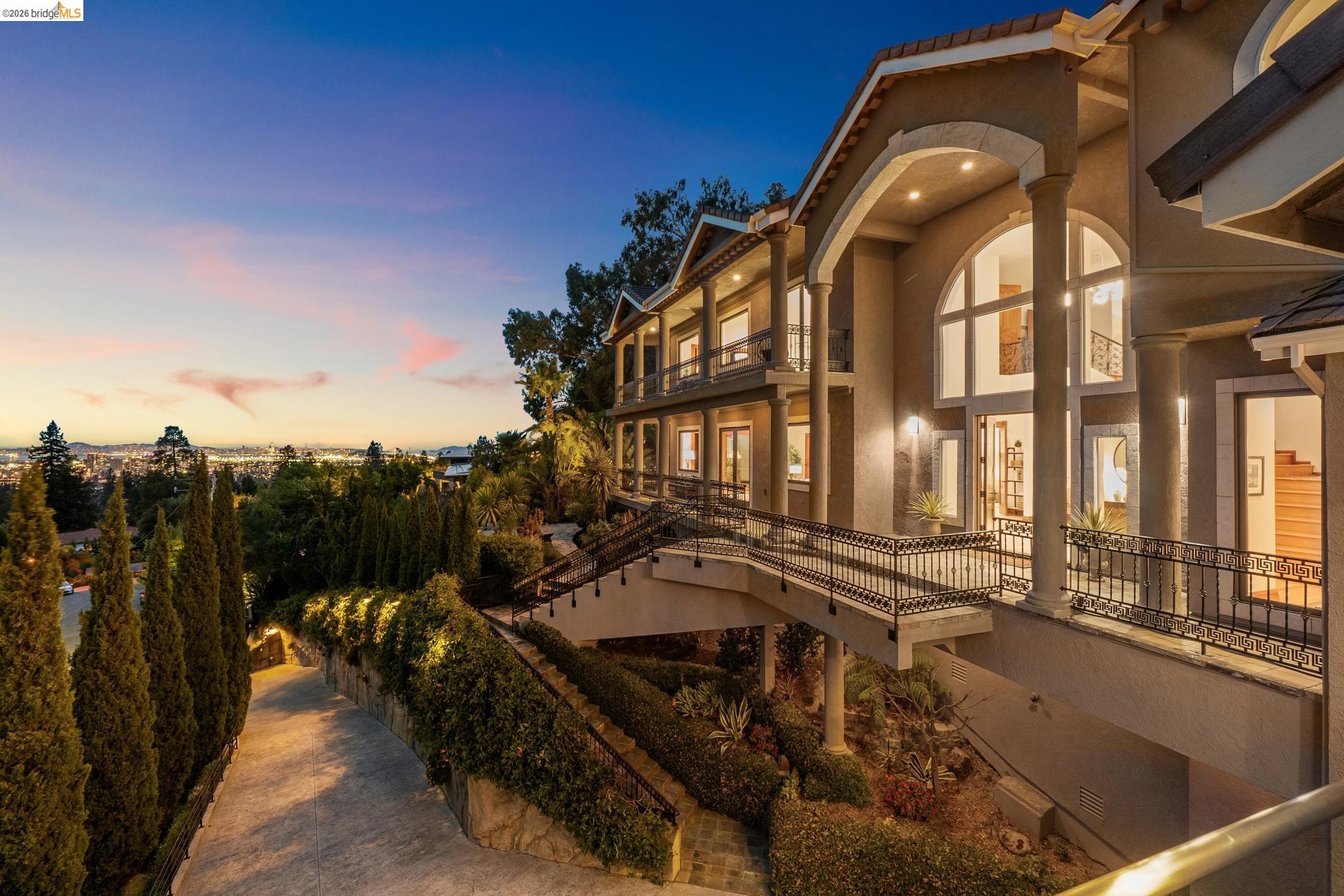33 Somerset Road Oakland, CA 94611 - Photo 1 of 1 Property exterior at dusk with stucco siding and a balcony