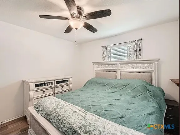 a bedroom with a bed and dresser