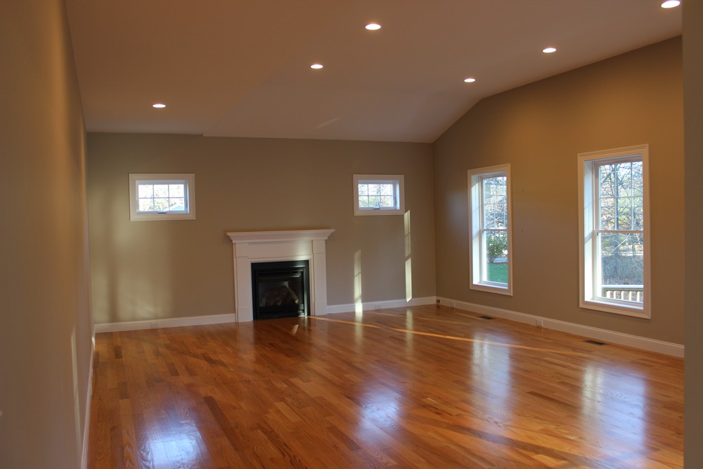 2 Silverbirch Road Billerica, MA 01821 - Photo 7 of 24 an empty room with wooden floor fireplace and windows