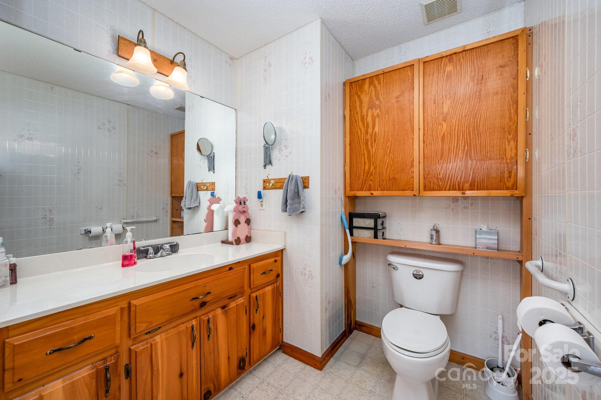 9595 Mt Olive Road Mount Pleasant, NC 28124 - Photo 11 of 26 a bathroom with a toilet sink and mirror