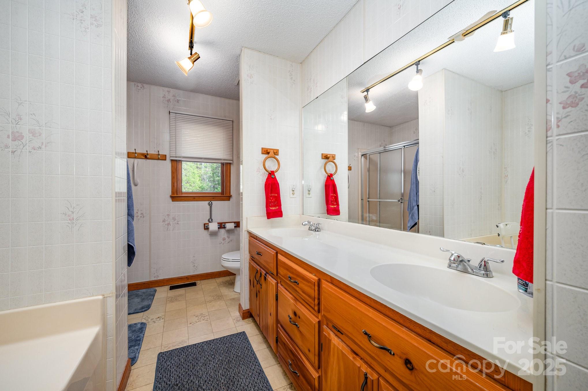 9595 Mt Olive Road Mount Pleasant, NC 28124 - Photo 13 of 26 a bathroom with a tub sink and mirror