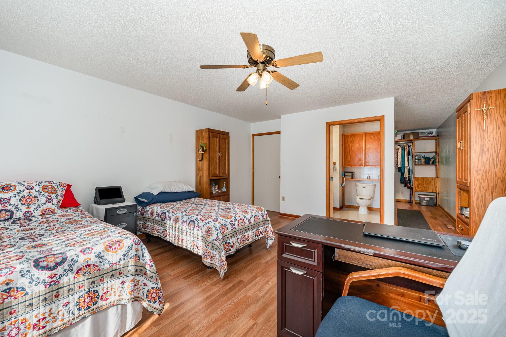 9595 Mt Olive Road Mount Pleasant, NC 28124 - Photo 9 of 26 a bedroom with two beds and a chandelier