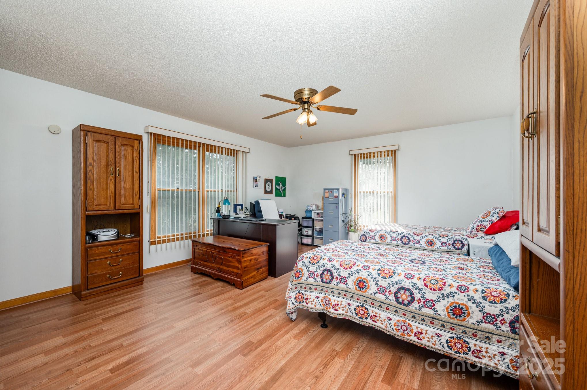 9595 Mt Olive Road Mount Pleasant, NC 28124 - Photo 10 of 26 a bedroom with a bed and a chandelier