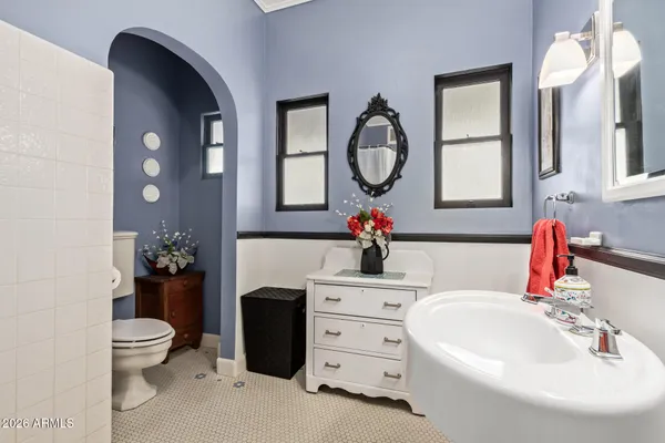 a bathroom with a toilet sink and mirror
