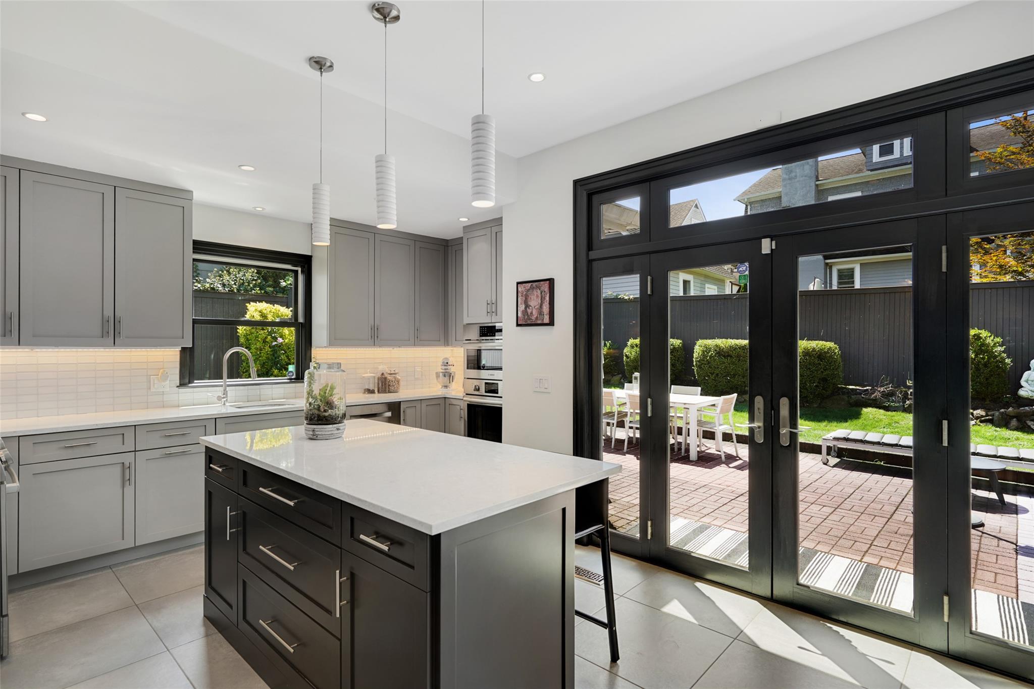 Welcome to 43 Rossmore Avenue featuring a fully renovated kitchen with stainless appliances, tile backsplash and amazing doors opening to the patio and yard.