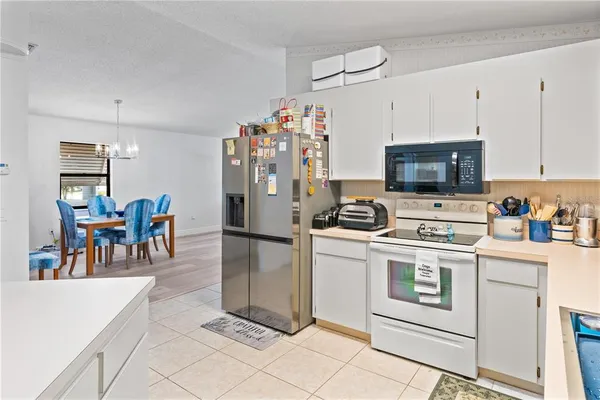 a kitchen with a white stove top oven and refrigerator