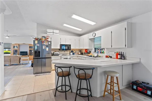 a kitchen with stainless steel appliances a sink a stove a refrigerator and cabinets