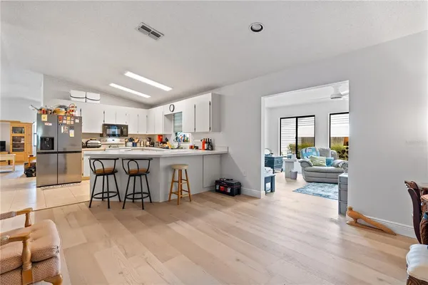 a living room with stainless steel appliances kitchen island granite countertop furniture and a kitchen view