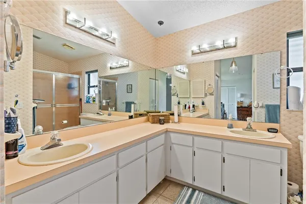 a spacious bathroom with a double vanity sink mirror and