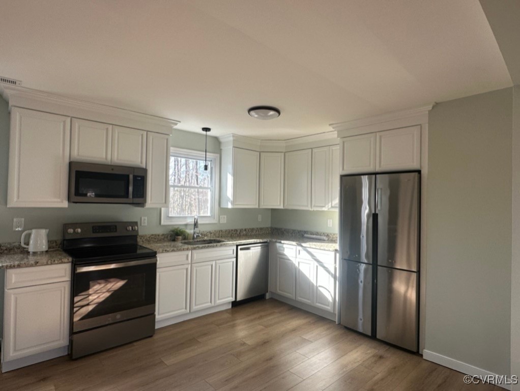 15810 Saddlebrook Road Chesterfield, VA 23838 - Photo 3 of 9 a kitchen with stainless steel appliances granite countertop a refrigerator stove a sink and white cabinets