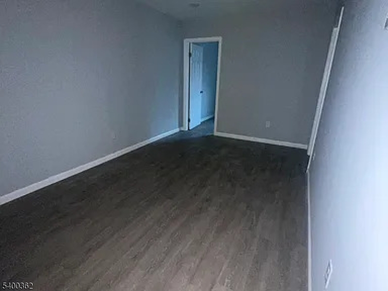 an empty room with wooden floor