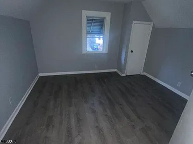 848 South 14th Street Newark, NJ 07108 - Photo 3 of 4 an empty room with wooden floor and windows