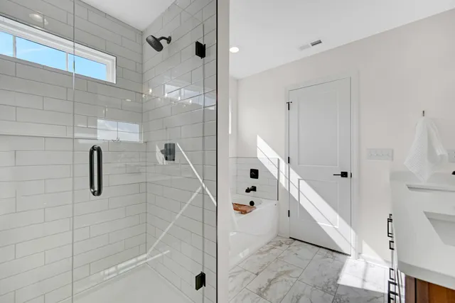 a bathroom with a bathtub and shower