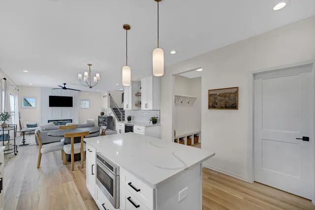 a open kitchen with stainless steel appliances granite countertop a sink a stove and a wooden floors