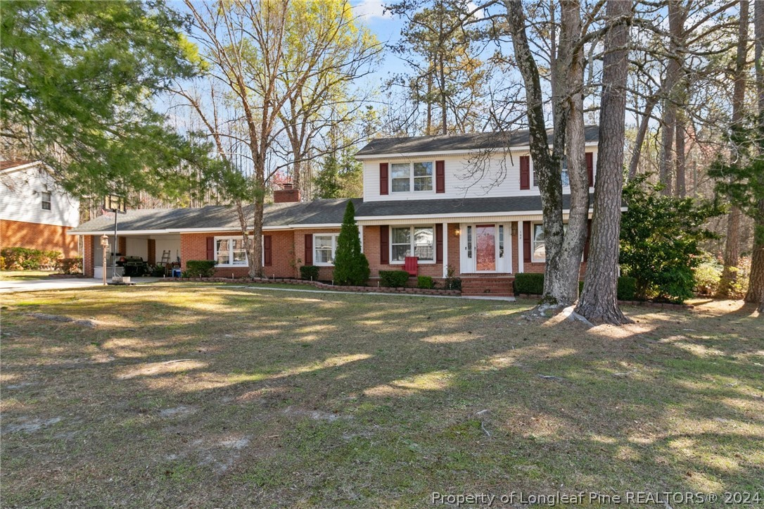 108 Mckinnon Drive Rockingham, NC 28379 - Photo 1 of 34 a front view of a house with a garden