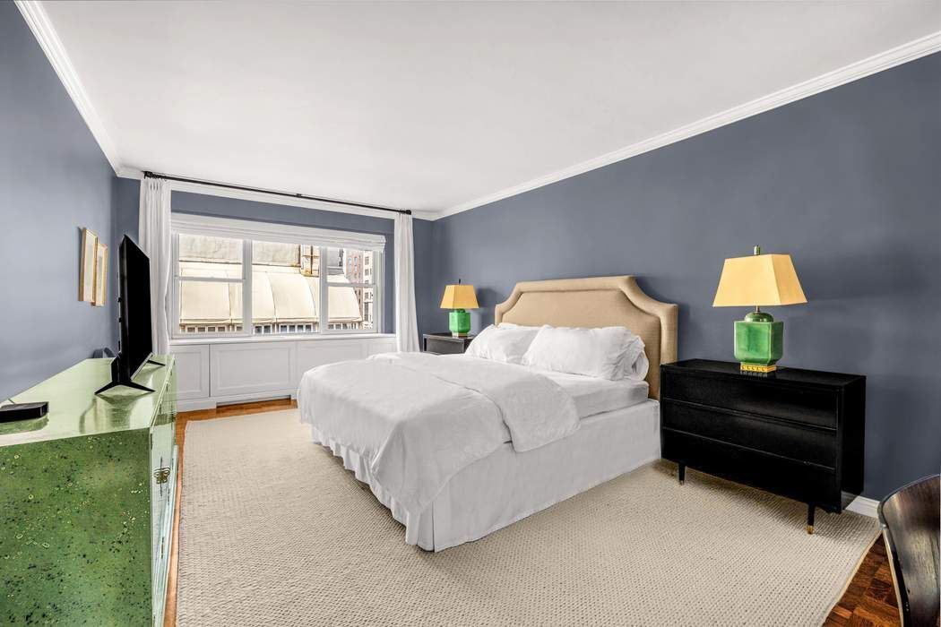50 East 79th Street, Unit 5B Manhattan, NY 10075 - Photo 5 of 12 a bedroom with a bed flat screen tv and window