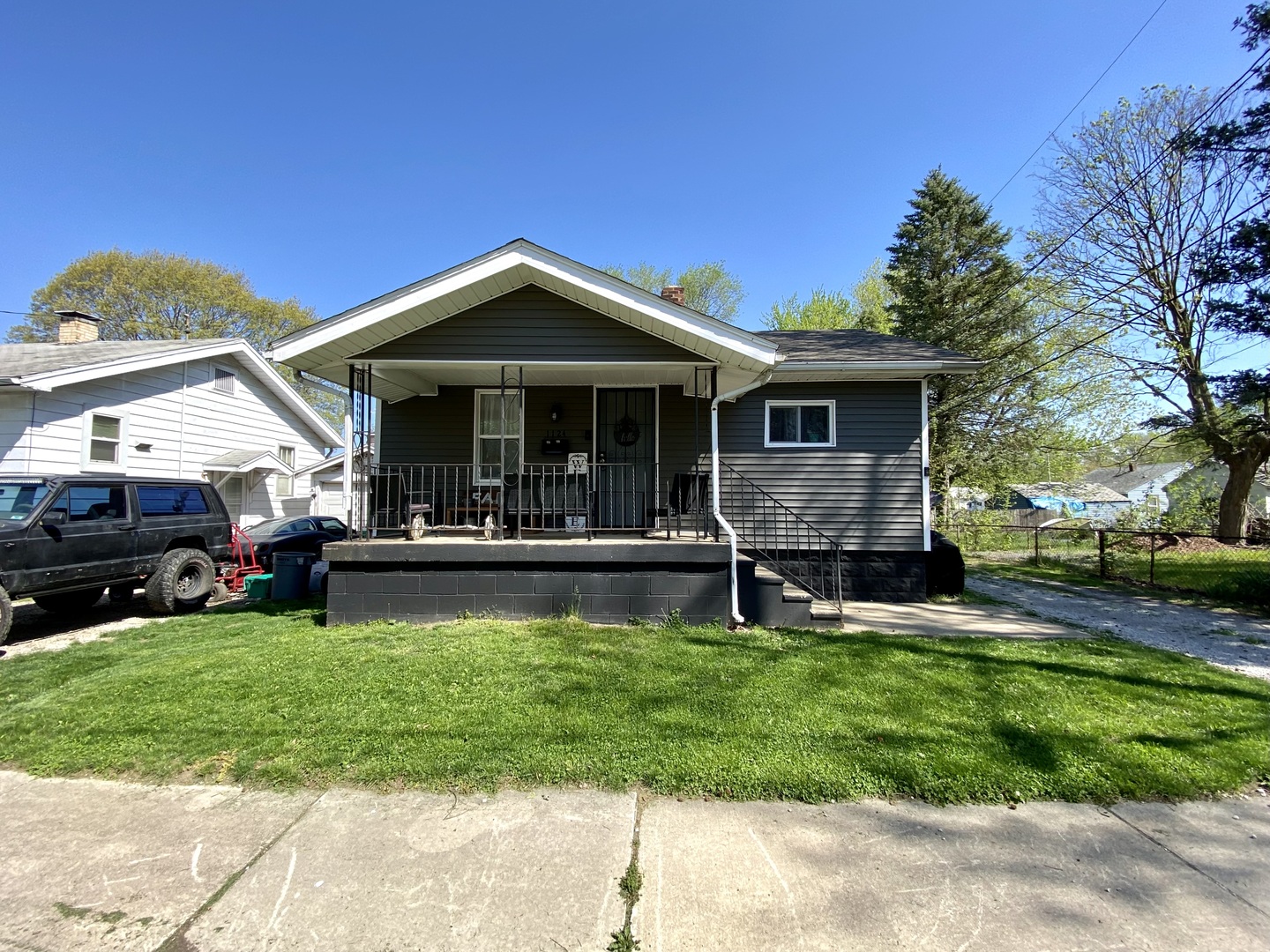 a view of a house with a yard porch and sitting area
