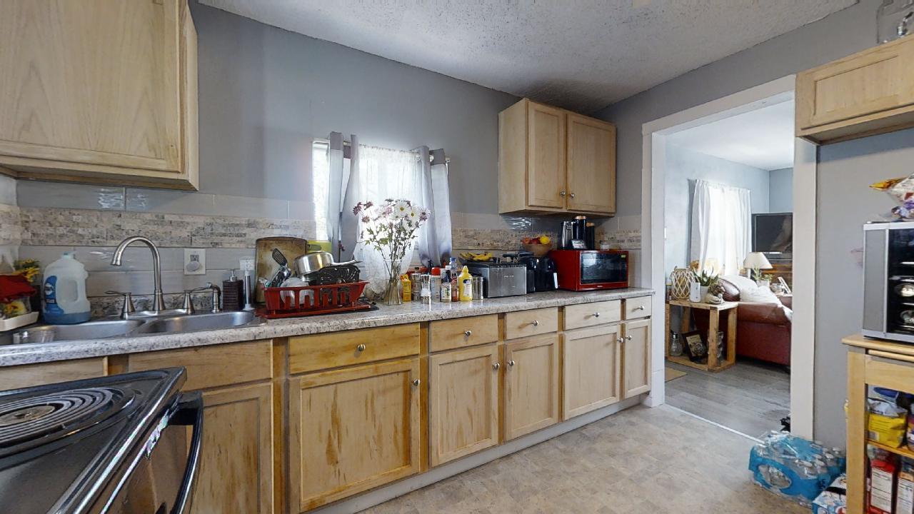 1124 West Cushing Street Decatur, IL 62526 - Photo 11 of 31 a kitchen with sink refrigerator and cabinets
