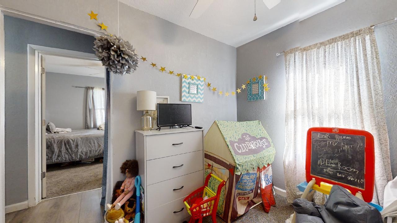 1124 West Cushing Street Decatur, IL 62526 - Photo 16 of 31 a bedroom with furniture and a flat screen tv