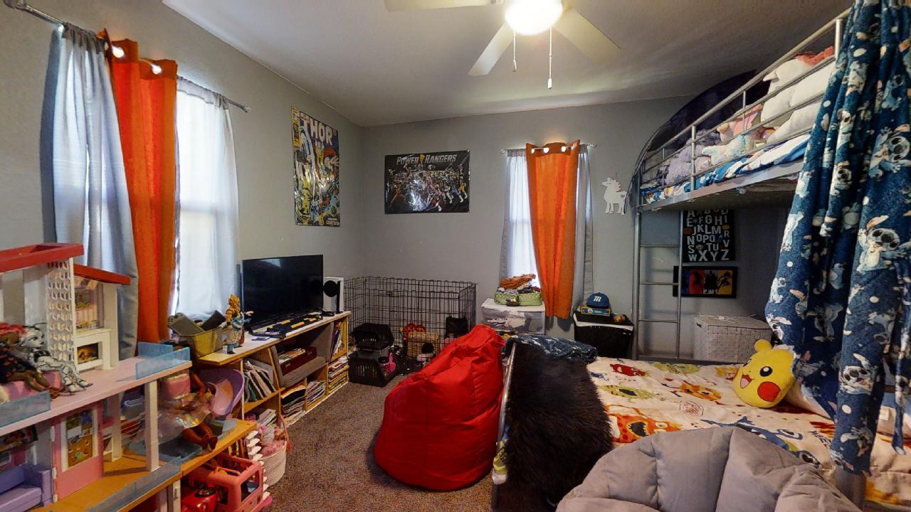 1124 West Cushing Street Decatur, IL 62526 - Photo 19 of 31 a bedroom with furniture and a flat screen tv