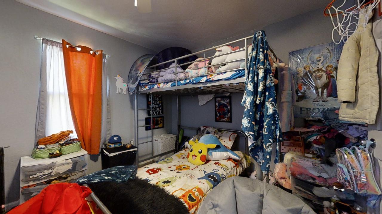 1124 West Cushing Street Decatur, IL 62526 - Photo 20 of 31 a bed sitting in a bedroom next to a window