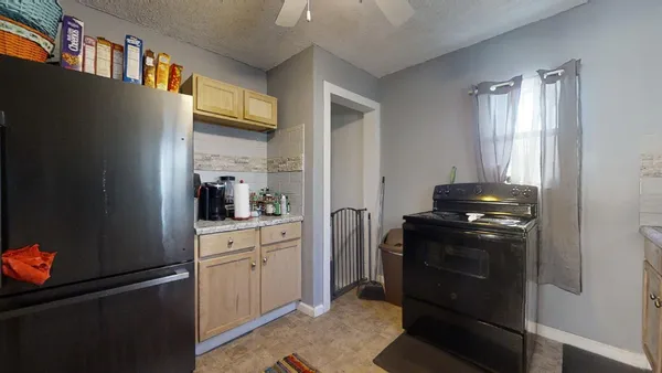 a kitchen with stainless steel appliances granite countertop a refrigerator and a stove top oven