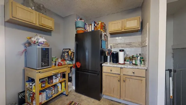 a kitchen with stainless steel appliances a refrigerator and a stove