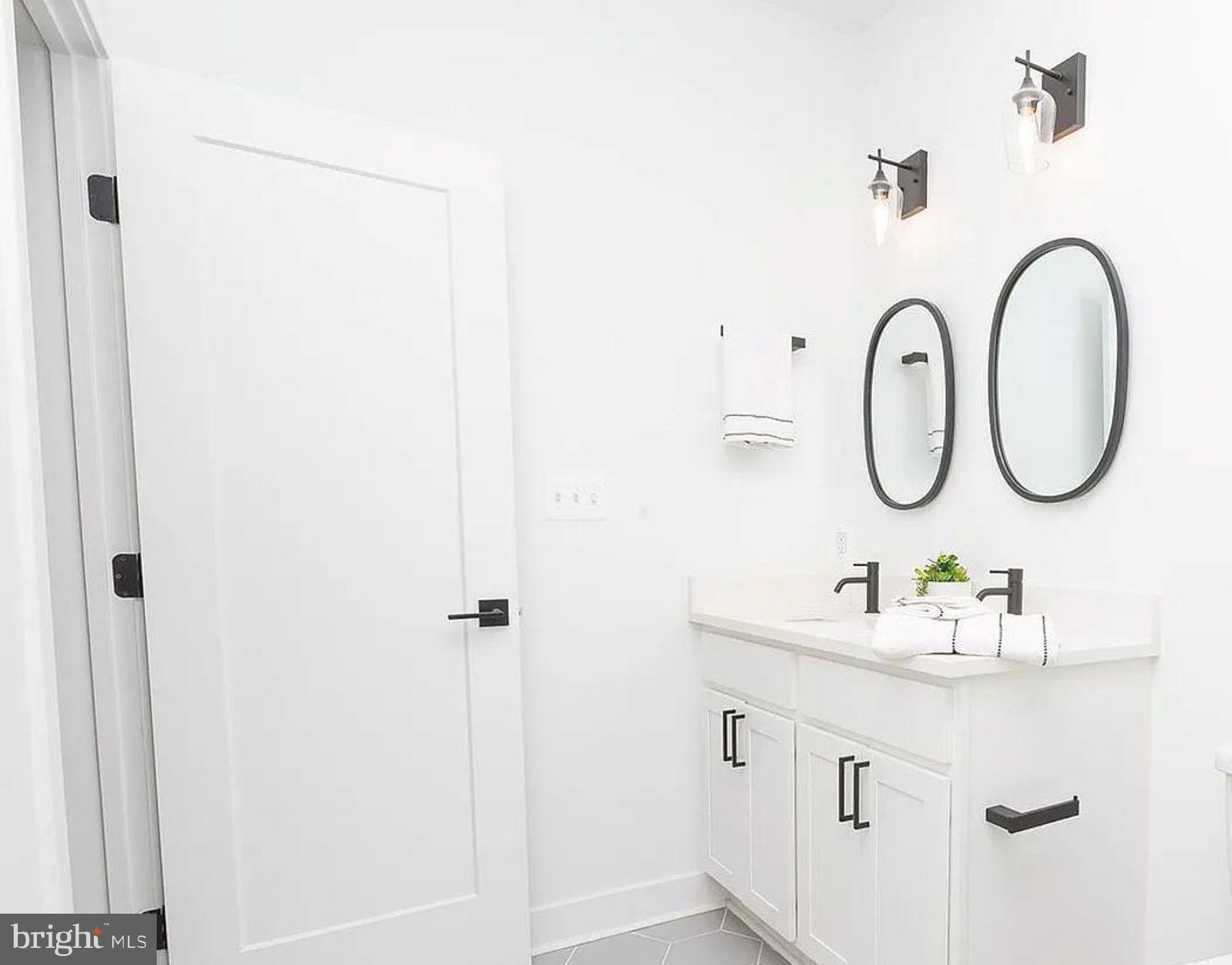 211 St Paul Street, Unit 504 Baltimore, MD 21202 - Photo 10 of 12 a bathroom with a sink and a mirror