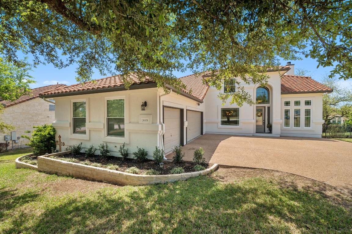 16108 Spillman Ranch Loop Austin, TX 78738 - Photo 1 of 40 a front view of a house with a yard