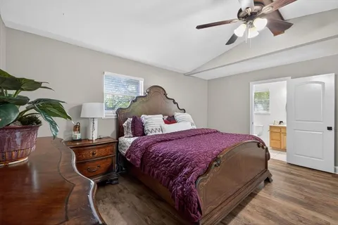 a bedroom with a bed a chandelier and closet