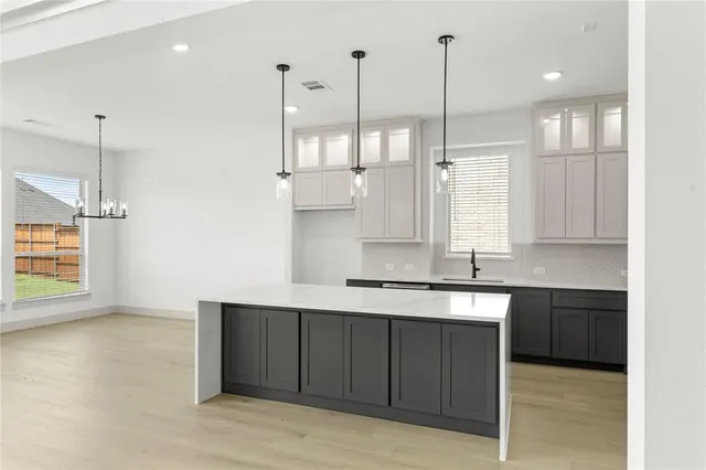 a kitchen with a sink refrigerator and window