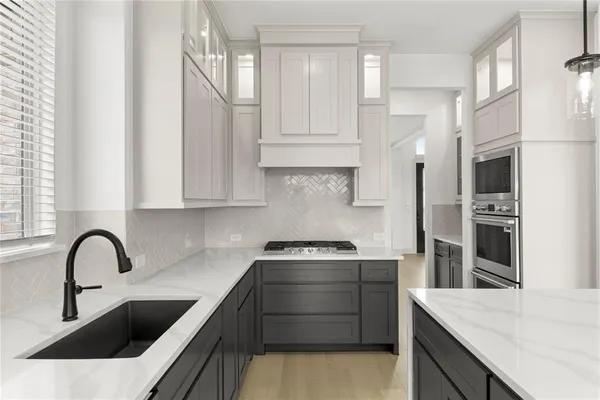 a kitchen with stainless steel appliances granite countertop a sink and a stove