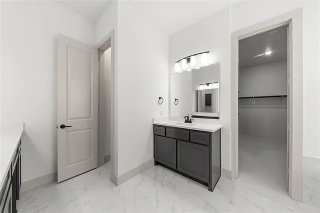 a spacious bathroom with a double vanity sink and a mirror