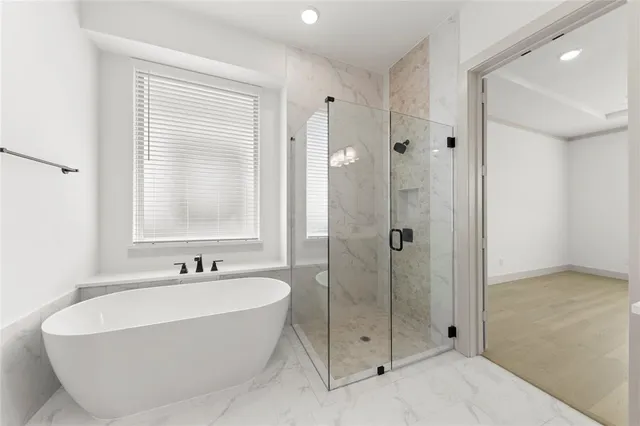 a bathroom with a bathtub and shower