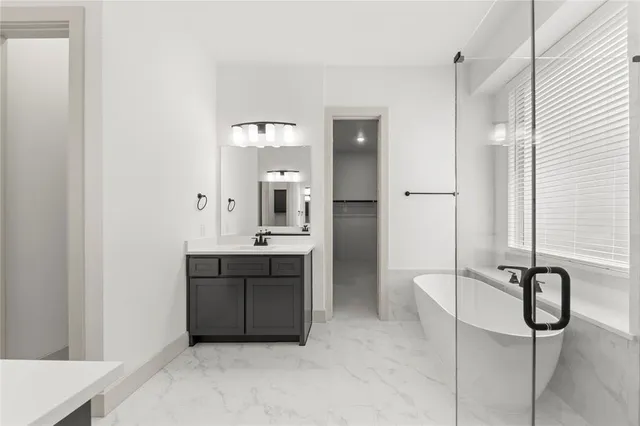 a spacious bathroom with a double vanity sink a mirror and shower