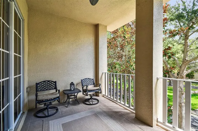 a living room with stainless steel appliances kitchen island granite countertop furniture and a large window