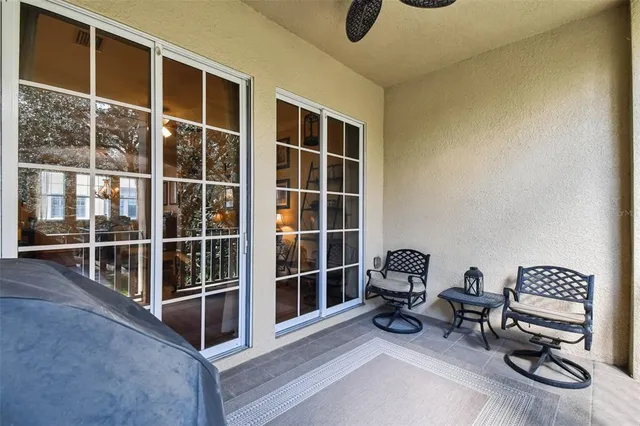a view of a dining room with furniture a chandelier and wooden floor