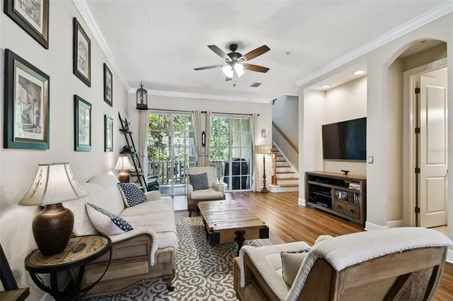 a kitchen with stainless steel appliances granite countertop a sink a stove a refrigerator cabinets and a dining table