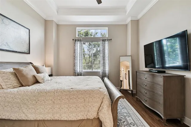 a living room with furniture a flat screen tv and a table