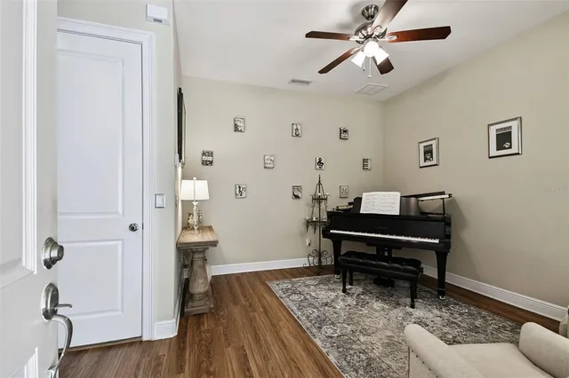 a living room with furniture and a piano