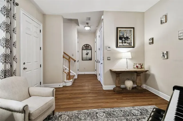a view of a hallway with wooden floor and entryway