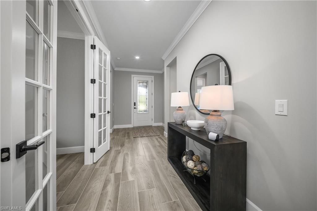 Decorative Glass impact front door and welcoming entry foyer is the perfect space to greet guests.
