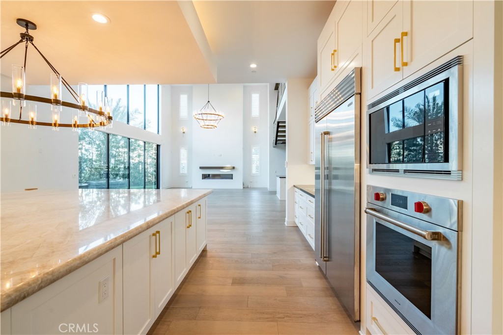 20043 Mersey Lane Porter Ranch, CA 91326 - Photo 12 of 68 a large white kitchen with a large window