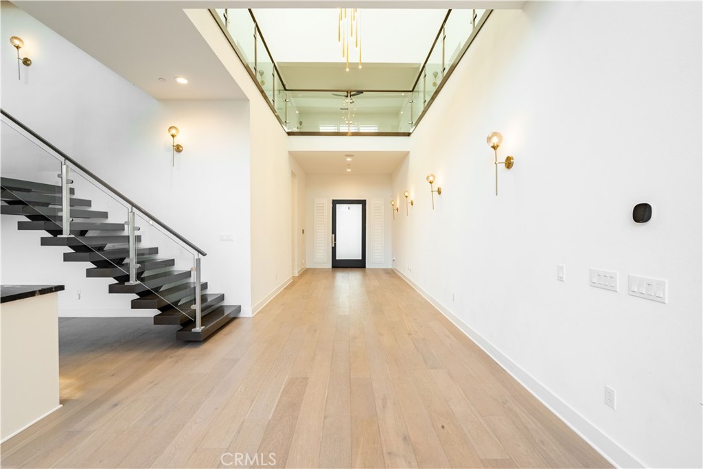 20043 Mersey Lane Porter Ranch, CA 91326 - Photo 18 of 68 a view of a hallway with wooden floor and staircase