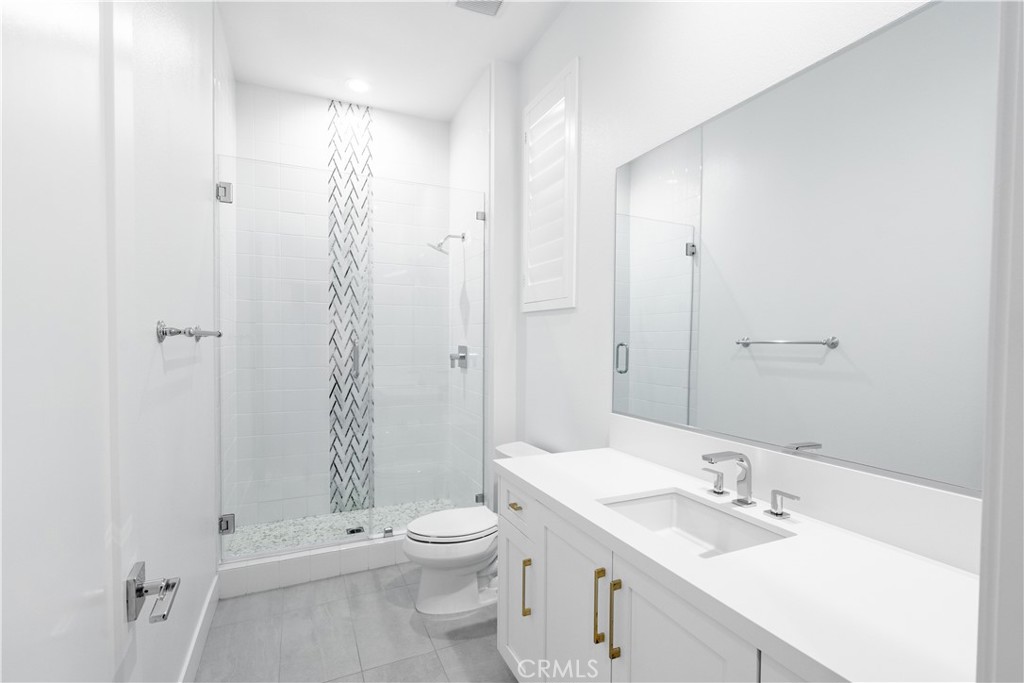 20043 Mersey Lane Porter Ranch, CA 91326 - Photo 26 of 68 a bathroom with a sink a toilet and shower